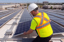 Man working on rooftop wearing the Hydrologic Hi Vis cooling Vest
